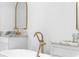 Close-up of an elegant bathroom featuring marble countertops, a luxurious soaking tub, and gold fixtures at 833 Martina Ne Dr, Atlanta, GA 30305