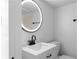 Modern bathroom with a sleek, illuminated mirror and dark fixtures for a stylish design at 833 Martina Ne Dr, Atlanta, GA 30305