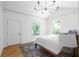 Bright bedroom featuring hardwood floors, an area rug, vaulted ceiling with modern light fixture, and two arched windows at 833 Martina Ne Dr, Atlanta, GA 30305