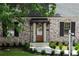 Inviting home entrance featuring a stylish awning, elegant door, and manicured landscaping at 833 Martina Ne Dr, Atlanta, GA 30305