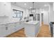 Modern kitchen with white cabinets, marble countertops, stainless steel appliances, and an island at 833 Martina Ne Dr, Atlanta, GA 30305