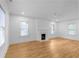 Spacious, airy living room with hardwood floors, white walls, and natural light from three windows at 833 Martina Ne Dr, Atlanta, GA 30305