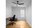 Modern office featuring a black ceiling fan, a sleek desk, a black office chair and hardwood floors at 833 Martina Ne Dr, Atlanta, GA 30305