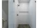 Modern shower with white herringbone tile, bronze fixtures and a glass enclosure at 833 Martina Ne Dr, Atlanta, GA 30305