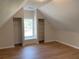 Finished attic space with wood-look flooring, built-in shelves, and a window seat at 219 Maple Creek, Woodstock, GA 30188