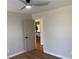 A bright bedroom with a view into another room, showcasing light-colored walls and wood-look flooring at 219 Maple Creek, Woodstock, GA 30188
