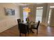 Charming dining room features wood-look floors, a glass table, and a stylish light fixture at 219 Maple Creek, Woodstock, GA 30188