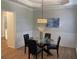 Inviting dining room with a glass table, seating for four, and elegant wall paneling at 219 Maple Creek, Woodstock, GA 30188