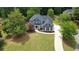 Beautiful two-story home with a well-manicured lawn and a long driveway at 219 Maple Creek, Woodstock, GA 30188