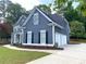 Well-maintained home showcasing gray siding, white trim, an attached two-car garage, and tidy landscaping at 219 Maple Creek, Woodstock, GA 30188