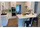 Bright kitchen features white cabinets, quartz countertops, and stainless steel appliances at 219 Maple Creek, Woodstock, GA 30188