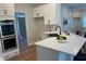Bright kitchen featuring white cabinets, stainless steel appliances, and quartz countertops at 219 Maple Creek, Woodstock, GA 30188