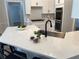 Well-lit kitchen features white cabinets, stainless steel appliances, and quartz countertops at 219 Maple Creek, Woodstock, GA 30188