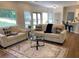 Inviting living room featuring neutral tones, natural light, and open access to the kitchen at 219 Maple Creek, Woodstock, GA 30188