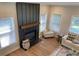 Top-down view of a cozy living room featuring hardwood floors, a cozy fireplace, and an area rug at 219 Maple Creek, Woodstock, GA 30188