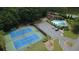 Community pool and tennis courts surrounded by lush landscaping and trees at 219 Maple Creek, Woodstock, GA 30188