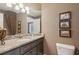 Modern bathroom features a vanity with a granite countertop, stylish fixtures, and decorative mirror at 3341 Anna Ruby Ln, Buford, GA 30519