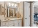 Cozy bathroom featuring granite countertop and a large framed mirror at 3341 Anna Ruby Ln, Buford, GA 30519