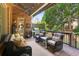 Cozy covered patio with comfortable seating, a grill, and a brick exterior at 3341 Anna Ruby Ln, Buford, GA 30519