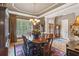 Formal dining room featuring hardwood floors, a large window, and elegant chandelier lighting at 3341 Anna Ruby Ln, Buford, GA 30519
