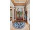 Elegant foyer with hardwood floors, decorative rug, and a view of the front doors at 3341 Anna Ruby Ln, Buford, GA 30519