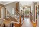 Spacious foyer featuring hardwood floors, staircase, and a view of the double front doors at 3341 Anna Ruby Ln, Buford, GA 30519
