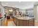 Spacious kitchen features a granite island with bar seating, stainless appliances, and hardwood floors at 3341 Anna Ruby Ln, Buford, GA 30519
