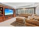 Spacious living room with a large entertainment center, comfortable sofa, and recessed lighting at 3341 Anna Ruby Ln, Buford, GA 30519