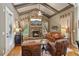 Cozy living room with a stone fireplace, vaulted ceilings, and large windows at 3341 Anna Ruby Ln, Buford, GA 30519
