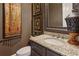 Elegant powder room with granite countertop, decorative mirror, and stylish fixtures at 3341 Anna Ruby Ln, Buford, GA 30519