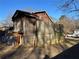 View of home's backyard displaying wooden fence and overgrown backyard landscape at 3709 Charlotte Dr, Rex, GA 30273