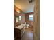 Bathroom featuring a wood vanity and a window for natural light at 3709 Charlotte Dr, Rex, GA 30273
