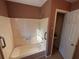 Clean bathroom showing shower and door to closet at 3709 Charlotte Dr, Rex, GA 30273