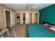 Bedroom featuring multiple closets for ample storage and a vibrant accent wall at 3709 Charlotte Dr, Rex, GA 30273