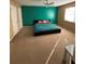 Bedroom showcasing a colorful accent wall, natural light, and plush carpeting at 3709 Charlotte Dr, Rex, GA 30273