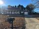 Charming one-story home with a covered porch and a well-maintained front yard with a long driveway at 3709 Charlotte Dr, Rex, GA 30273