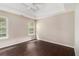 Well-lit bedroom features hardwood floors, two windows, and neutral colored walls at 4615 Thermal Ct, Douglasville, GA 30135