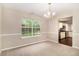 Charming dining room with neutral walls, carpet, and a large window for natural light at 4615 Thermal Ct, Douglasville, GA 30135