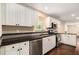 Modern kitchen featuring stainless steel appliances, white cabinets, and dark countertops at 4615 Thermal Ct, Douglasville, GA 30135
