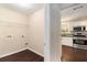 Bright laundry room area leading to the kitchen featuring modern stainless steel appliances at 4615 Thermal Ct, Douglasville, GA 30135