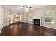 Open-concept living room with a fireplace and hardwood floors leading to the kitchen at 4615 Thermal Ct, Douglasville, GA 30135