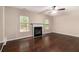 Spacious living room with a fireplace, ceiling fan, and large windows at 4615 Thermal Ct, Douglasville, GA 30135