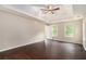 Bright and airy primary bedroom with a tray ceiling, fan, and hardwood floors at 4615 Thermal Ct, Douglasville, GA 30135