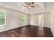 Spacious primary bedroom with a tray ceiling, ceiling fan, hardwood floors, and two windows at 4615 Thermal Ct, Douglasville, GA 30135