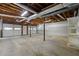 Unfinished basement space with exposed ceiling and dual garage door access, offering potential for customization at 670 Dena Dr, Canton, GA 30114