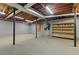 Unfinished basement space featuring exposed beams, concrete foundation, and shelving at 670 Dena Dr, Canton, GA 30114