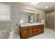 Well-lit bathroom featuring a double vanity, separate shower, and garden tub with a window at 670 Dena Dr, Canton, GA 30114