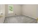 Cozy bedroom with neutral carpet, a window providing natural light, and ample space at 670 Dena Dr, Canton, GA 30114