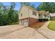 Side view of house showing brick foundation, 2 car garage and landscaped yard at 670 Dena Dr, Canton, GA 30114