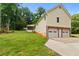 Lawn view showing house, 2 car garage and deck at 670 Dena Dr, Canton, GA 30114